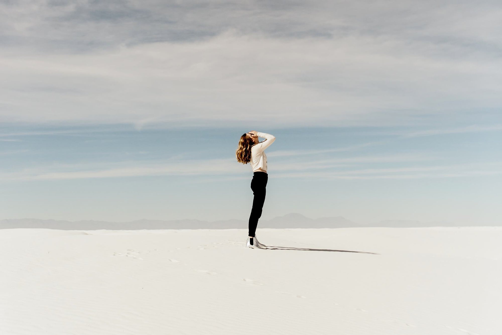 Woman standing alone in the desert during the daytime