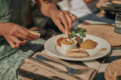 Woman eating Mediterranean foods in the sun for gut health