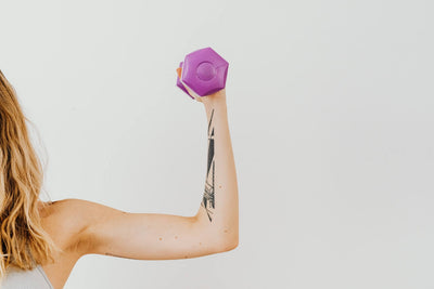 Woman exercising holding a weight in one hand