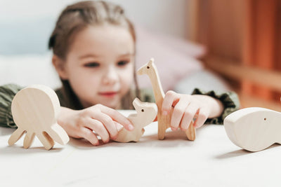 Young girl playing with wooden blocks