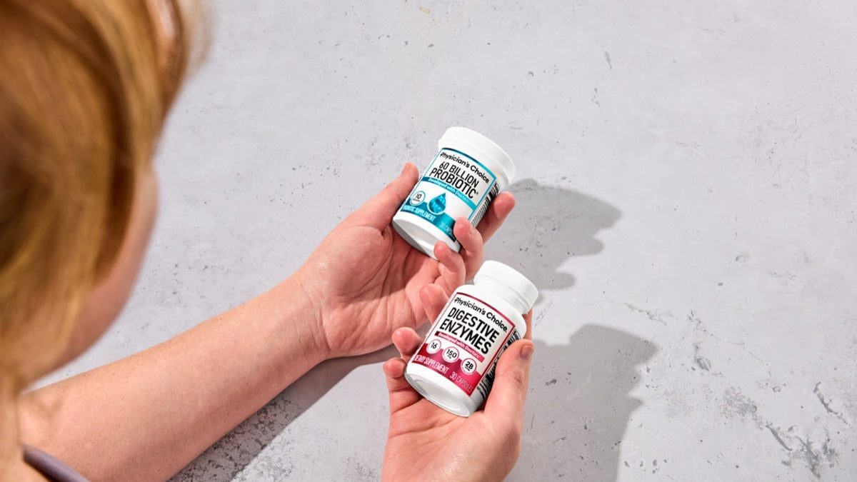 Holding the two Hack Your Tummy bottles