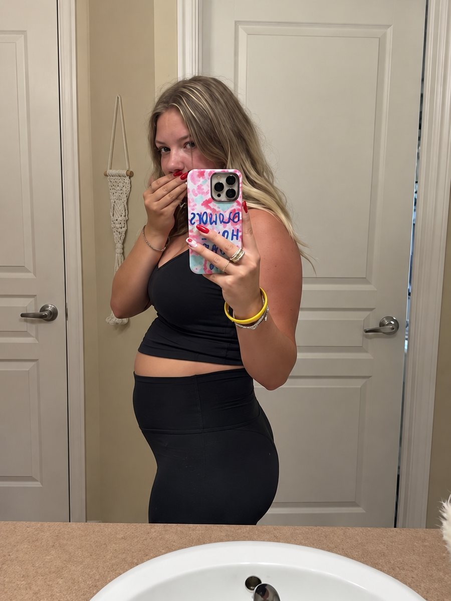 Woman showing her bloated stomach