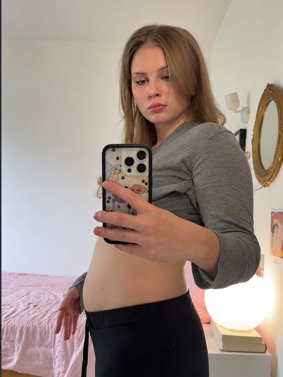 Woman showing her bloated stomach