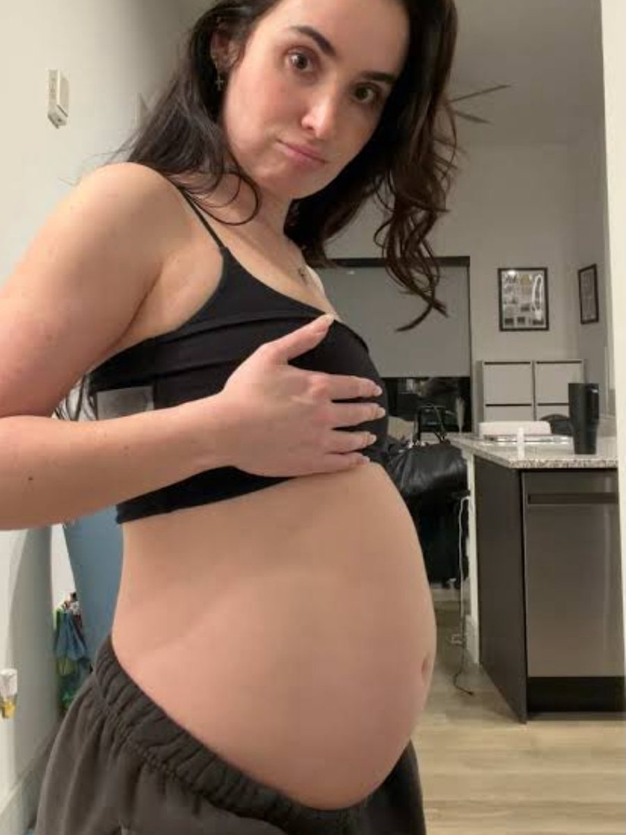 Woman showing her bloated stomach
