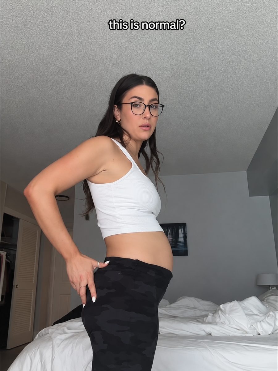 Woman showing her bloated stomach