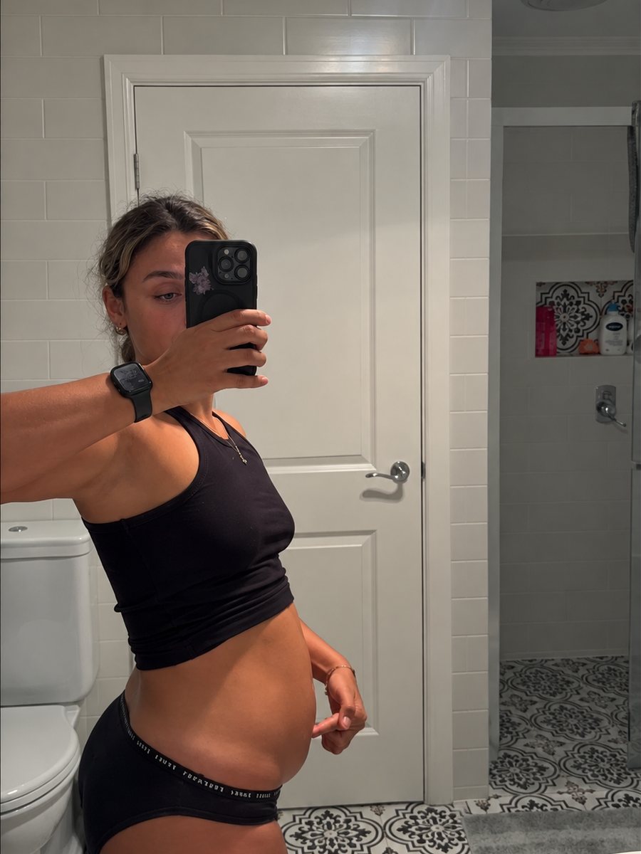 Woman showing her bloated stomach