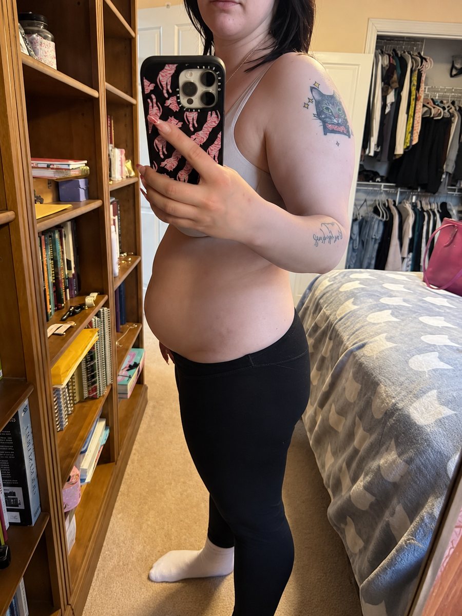 Woman showing her bloated stomach