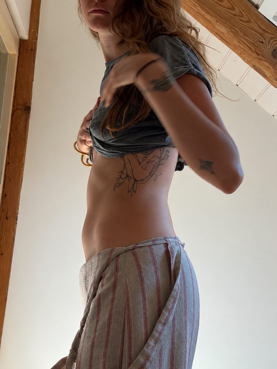 Woman showing her bloated stomach