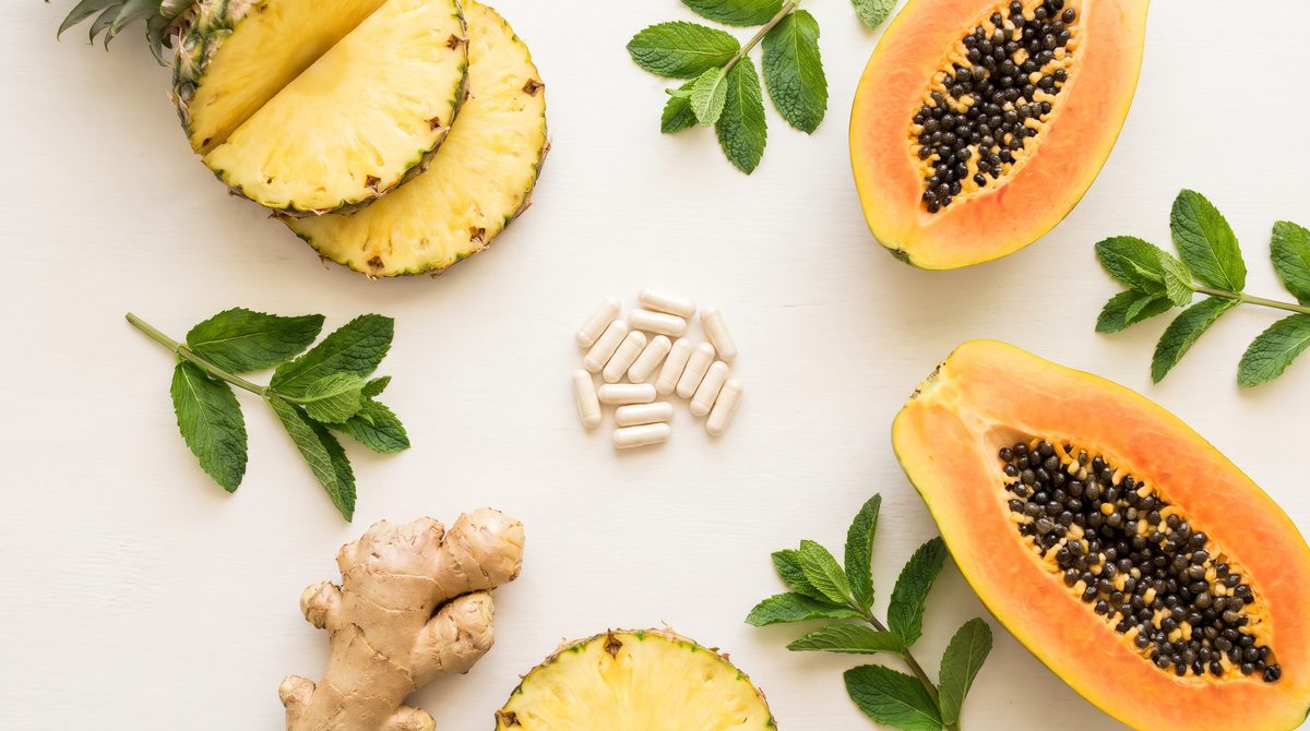 Digestive enzyme capsule next to a full meal