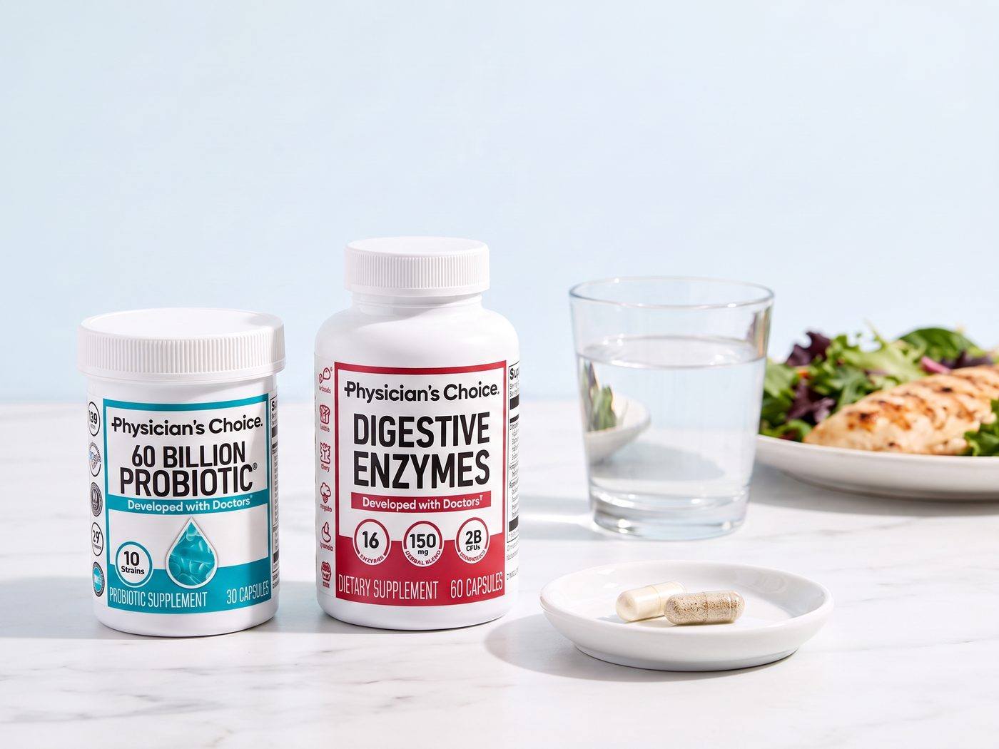 The Physician's Choice 60 Billion Probiotic and Digestive Enzymes bottles with one capsule from each and a glass of water