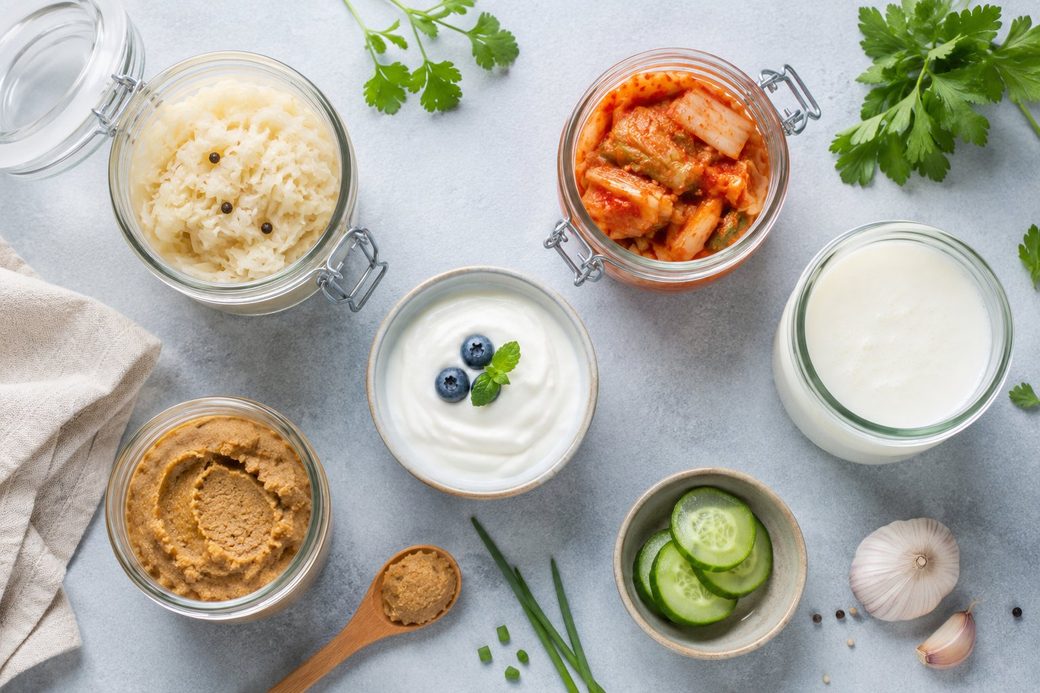 Assortment of fermented foods: kimchi, sauerkraut, yogurt, kefir