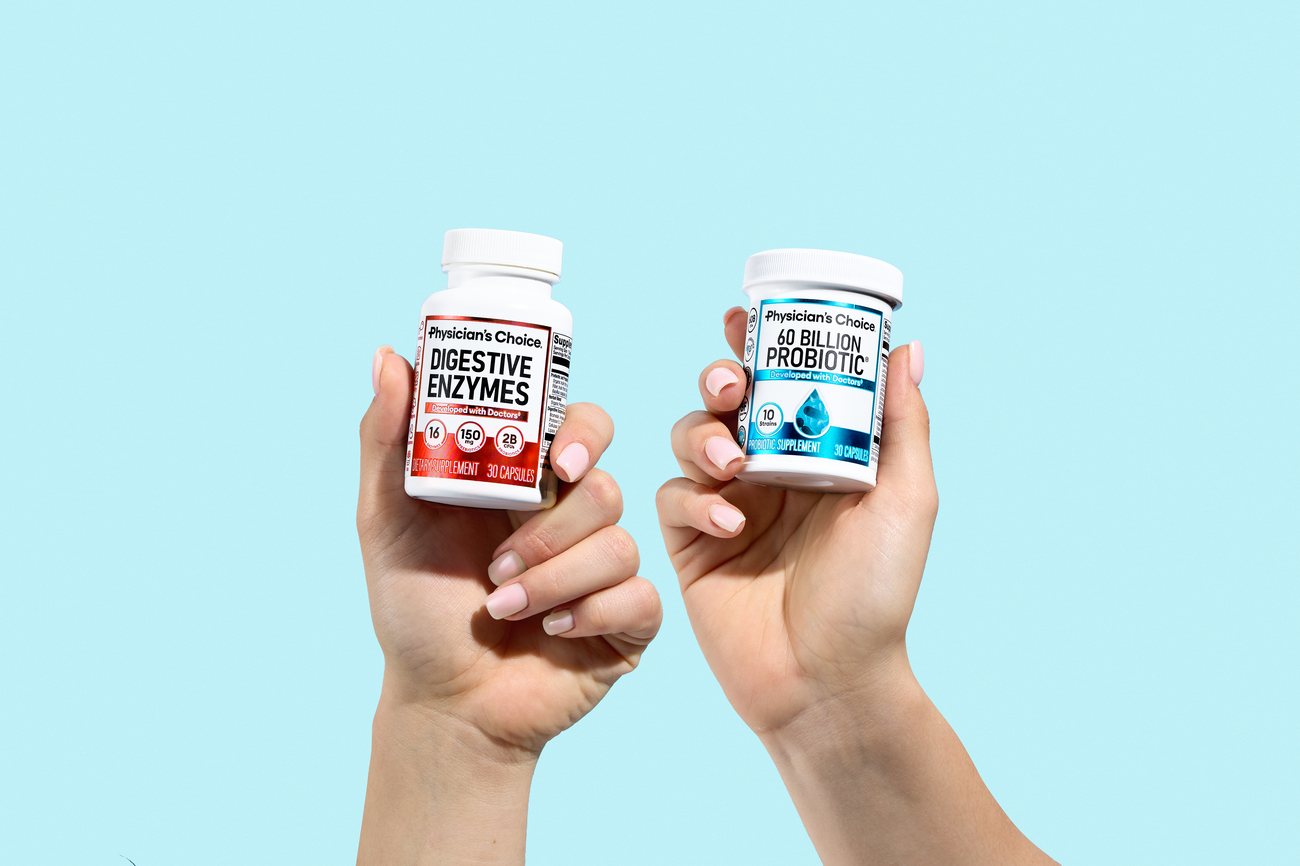 Hands holding Physician's Choice Digestive Enzymes and 60 Billion Probiotic bottles