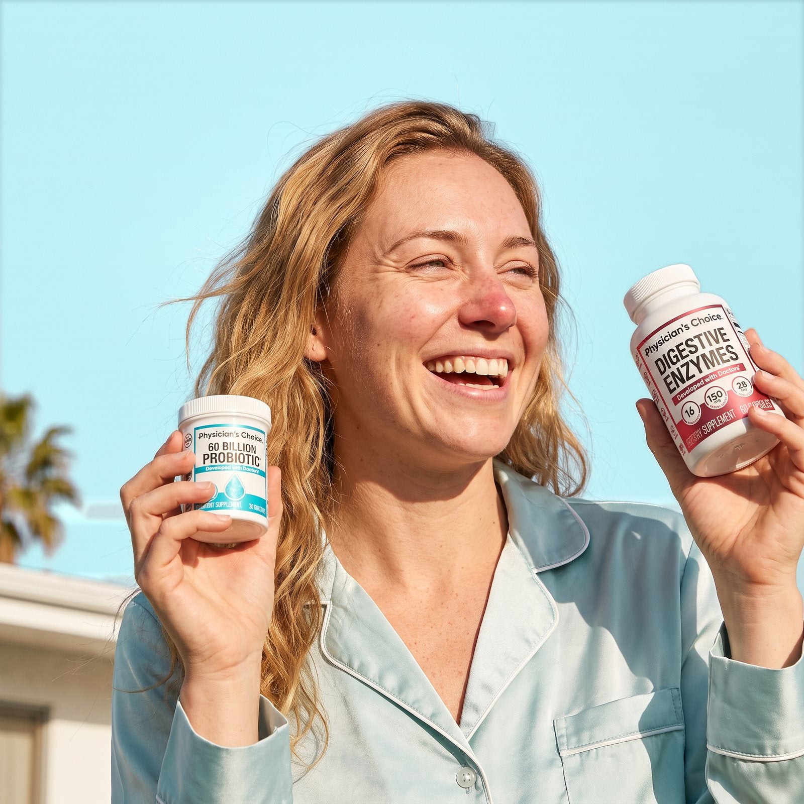Smiling woman in pyjamas holding Physician's Choice 60 Billion Probiotic and Digestive Enzymes
